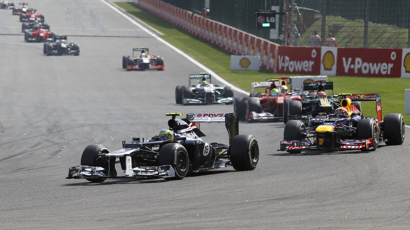 Formula One Cars Racing — Black, Competitive, Afternoon, Photograph, Race Track, Safety Barriers, Drivers