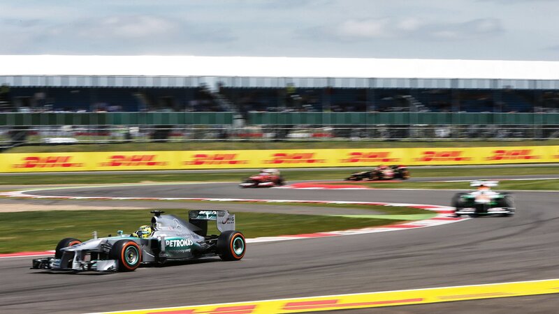 Formula One Cars Racing — Gray, Dynamic, Afternoon, Photograph, Race Track, Spectator Stands
