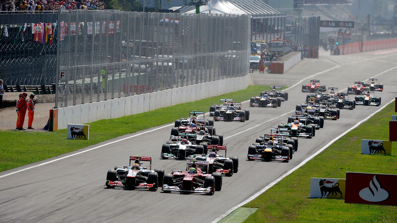 Formula One Cars Racing — Gray, Dynamic, Afternoon, Photograph, Race Track, Spectators, Fencing