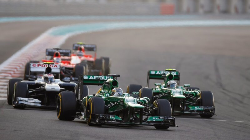 Formula One Cars Racing — Green, Competitive, Sunset
