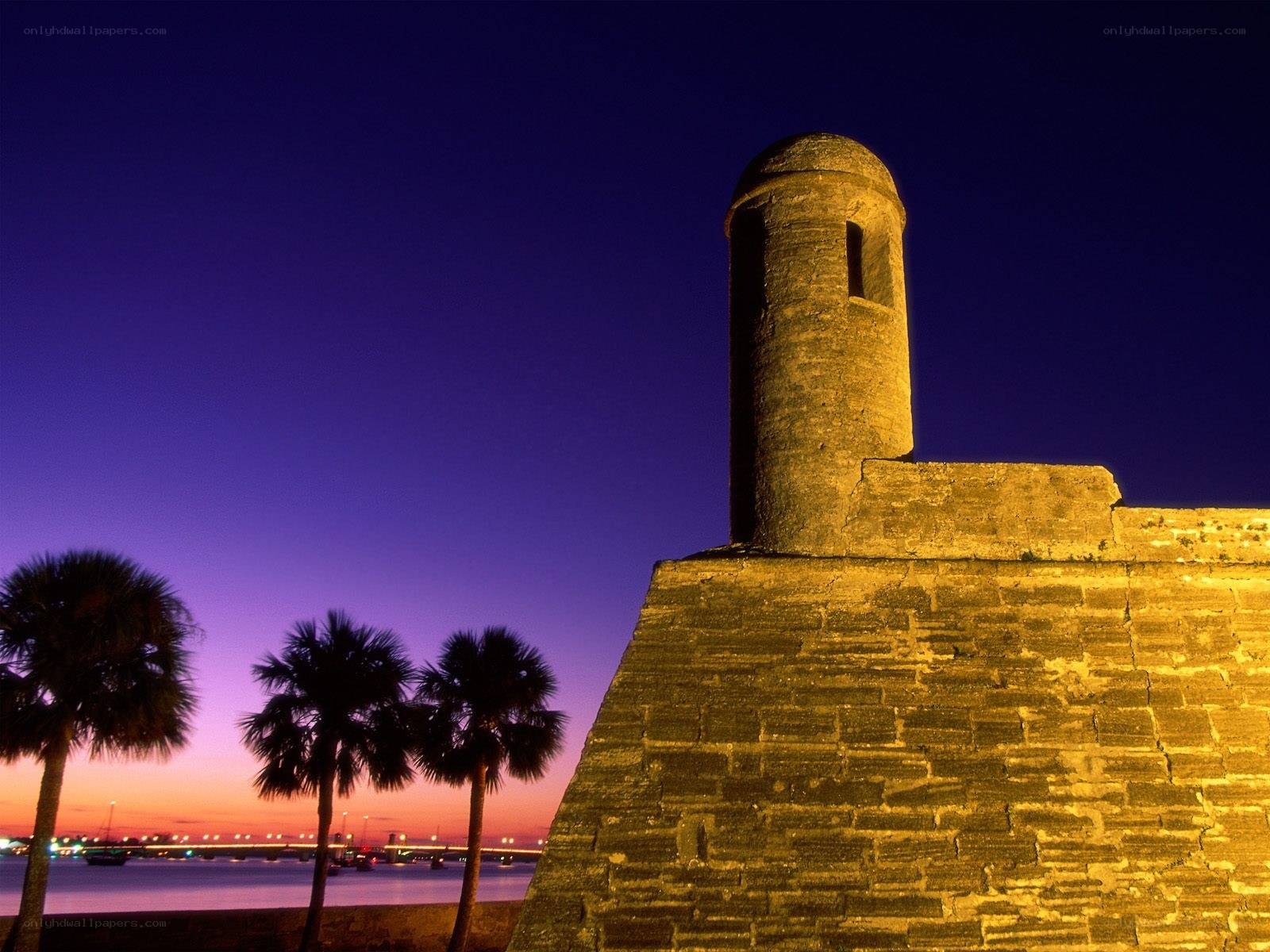 Fort at dusk with palm trees