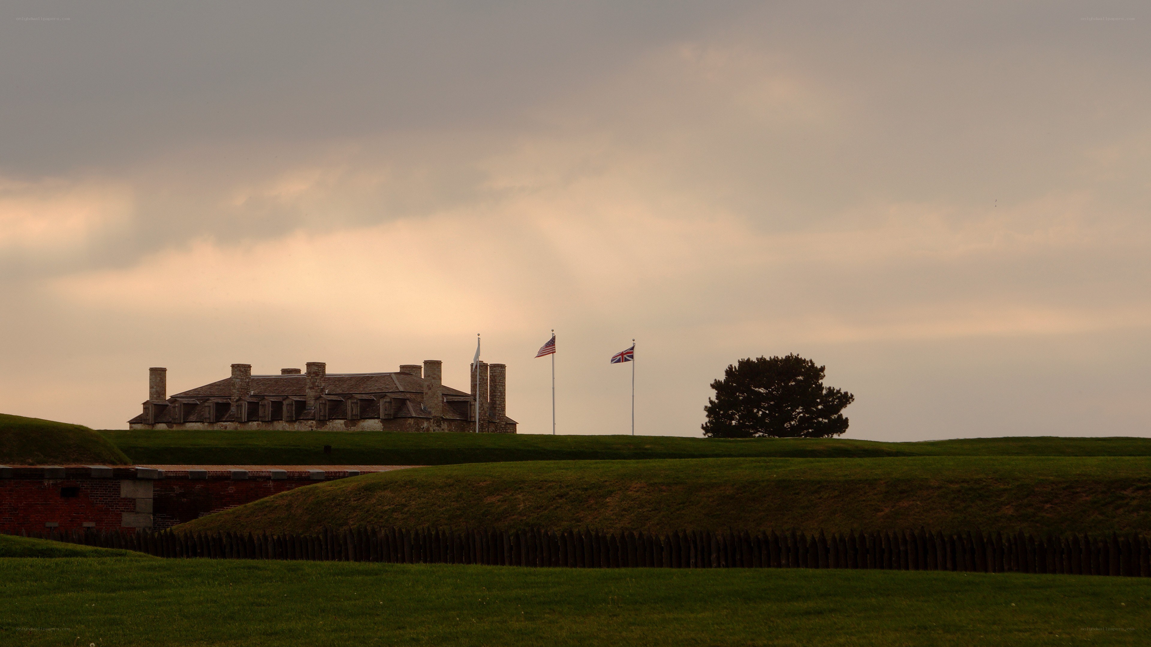 Fort at sunset with flags