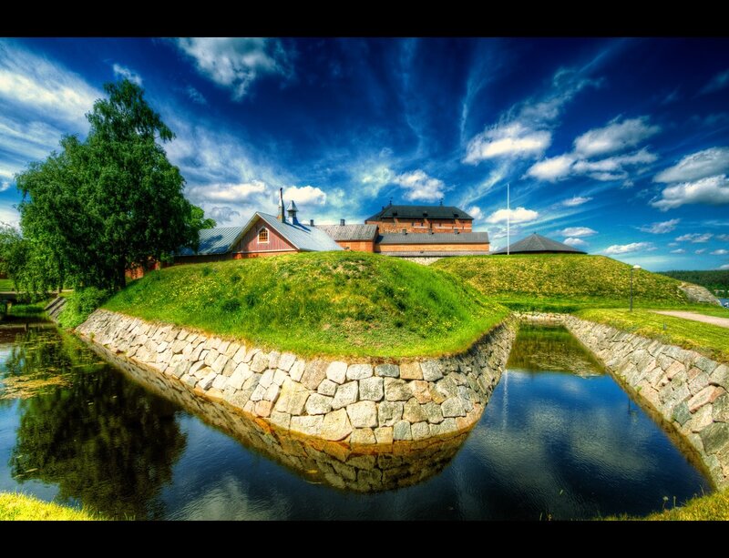 Fortress with moat and green hill