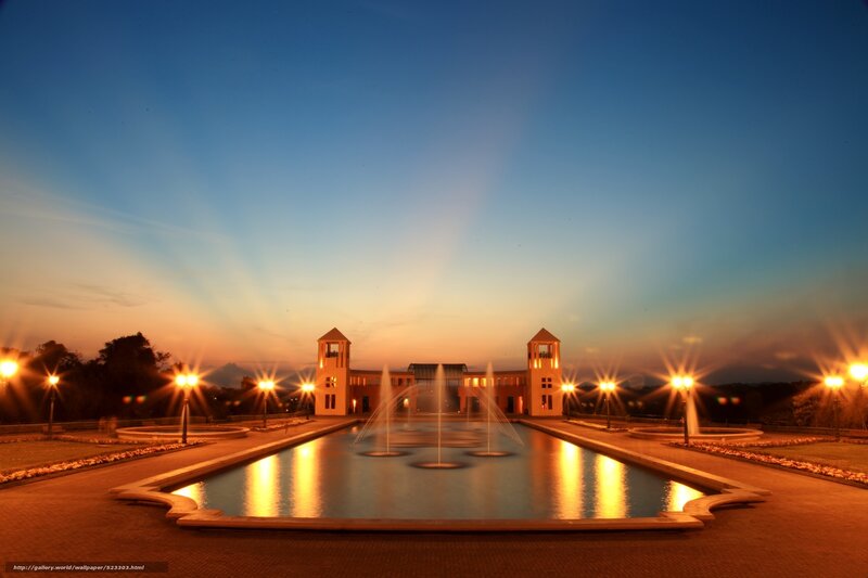 Fountain at dusk with illuminated towers