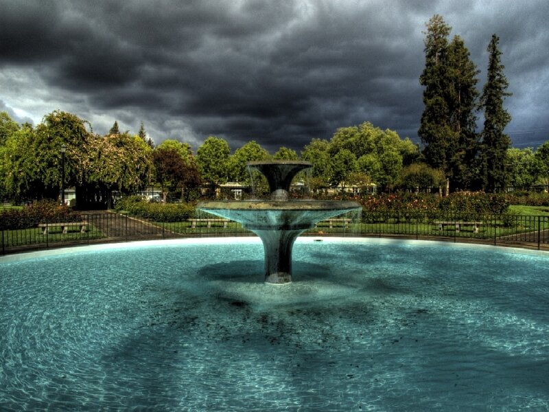 Fountain in a park under stormy sky
