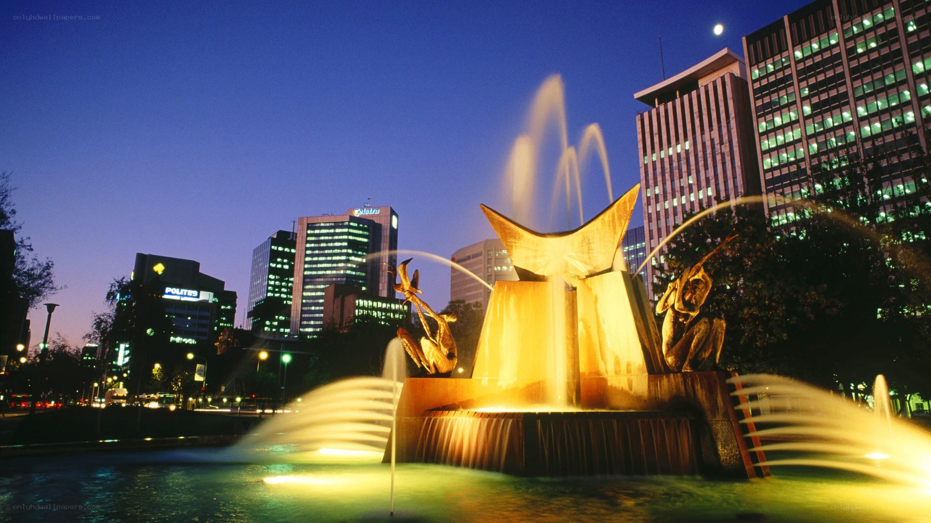 fountain in city at dusk