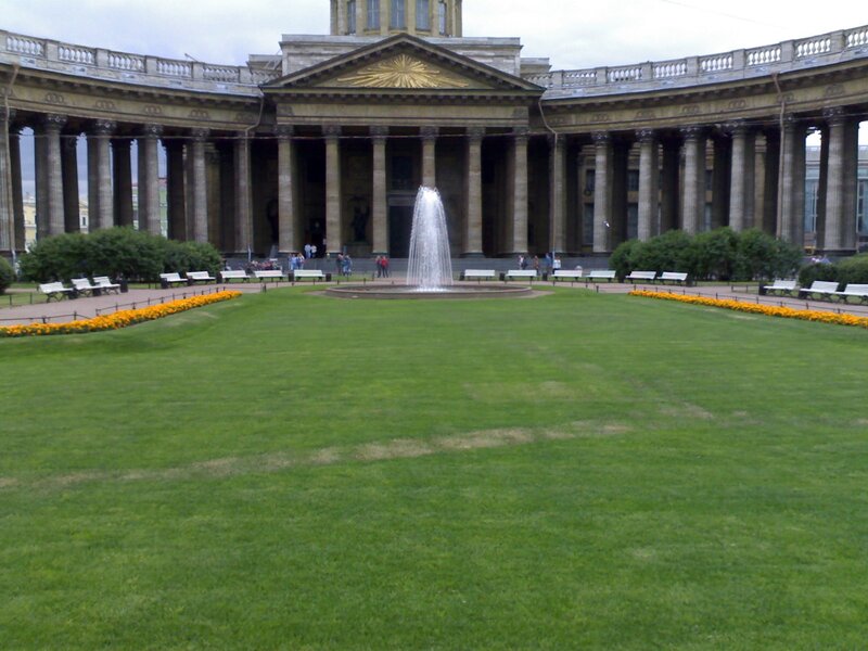 fountain in front of a grand building