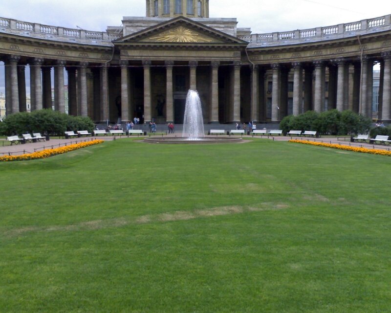 fountain in front of a grand building