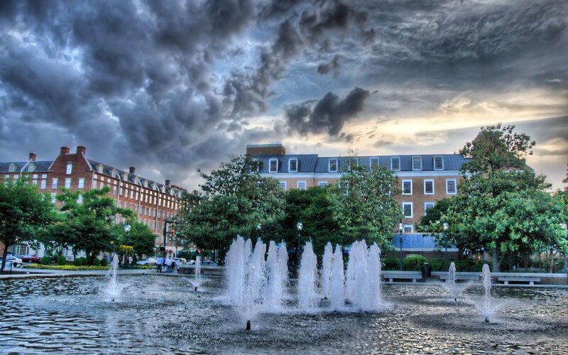 Fountain in front of brick buildings