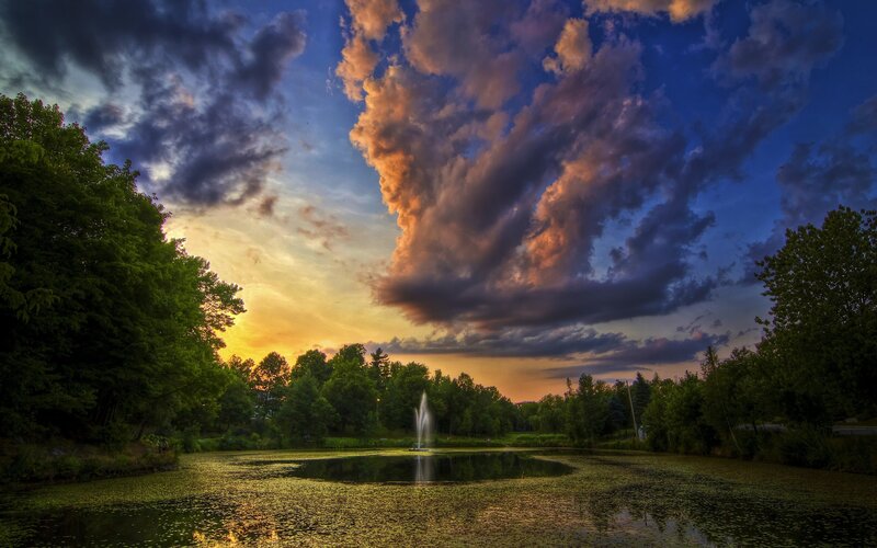 Fountain in Pond at Sunset — Blue, Dramatic, Photograph, Trees