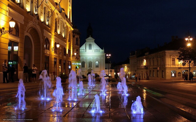 Fountain in town square at night