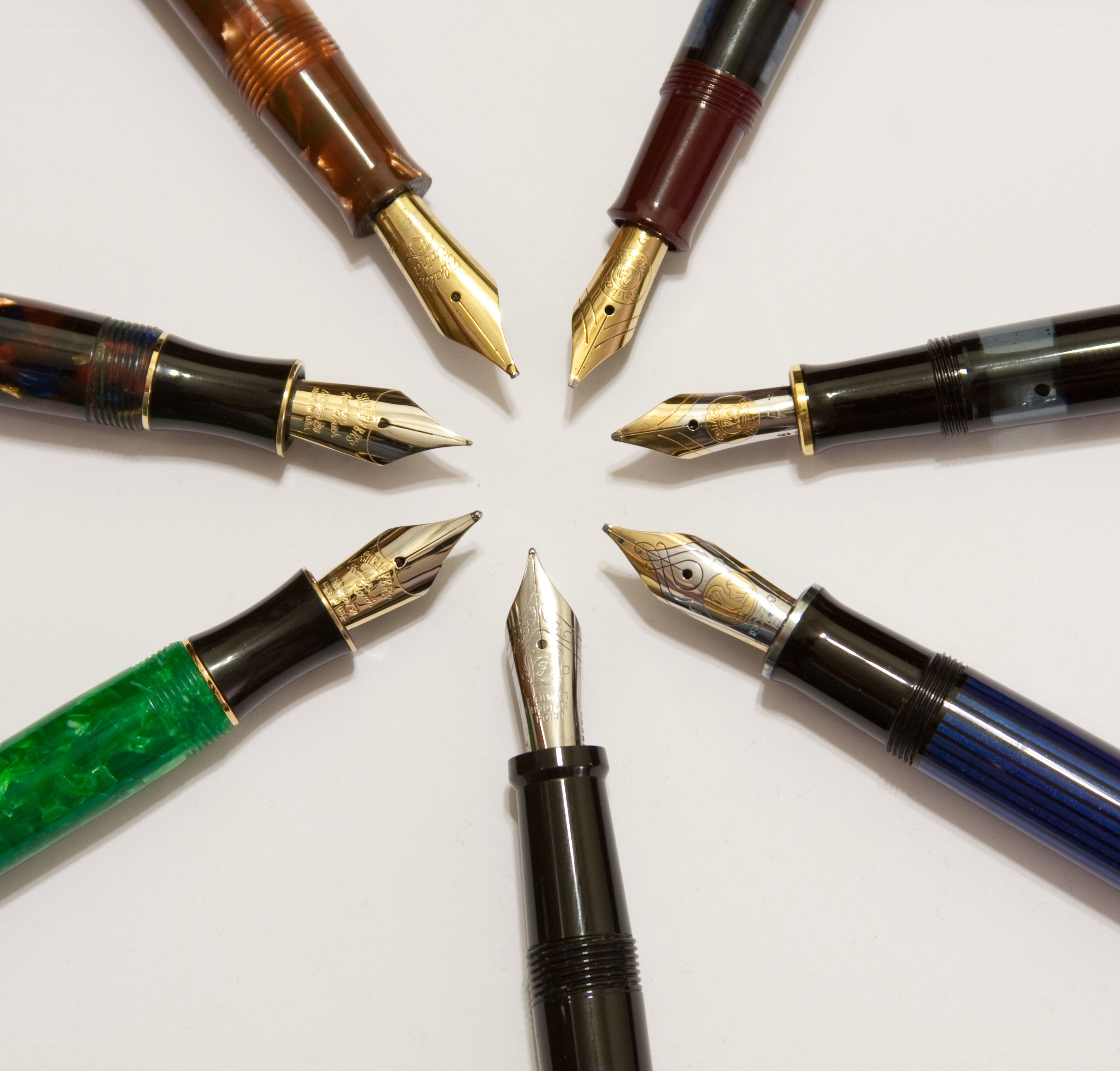 fountain pens arranged in circle