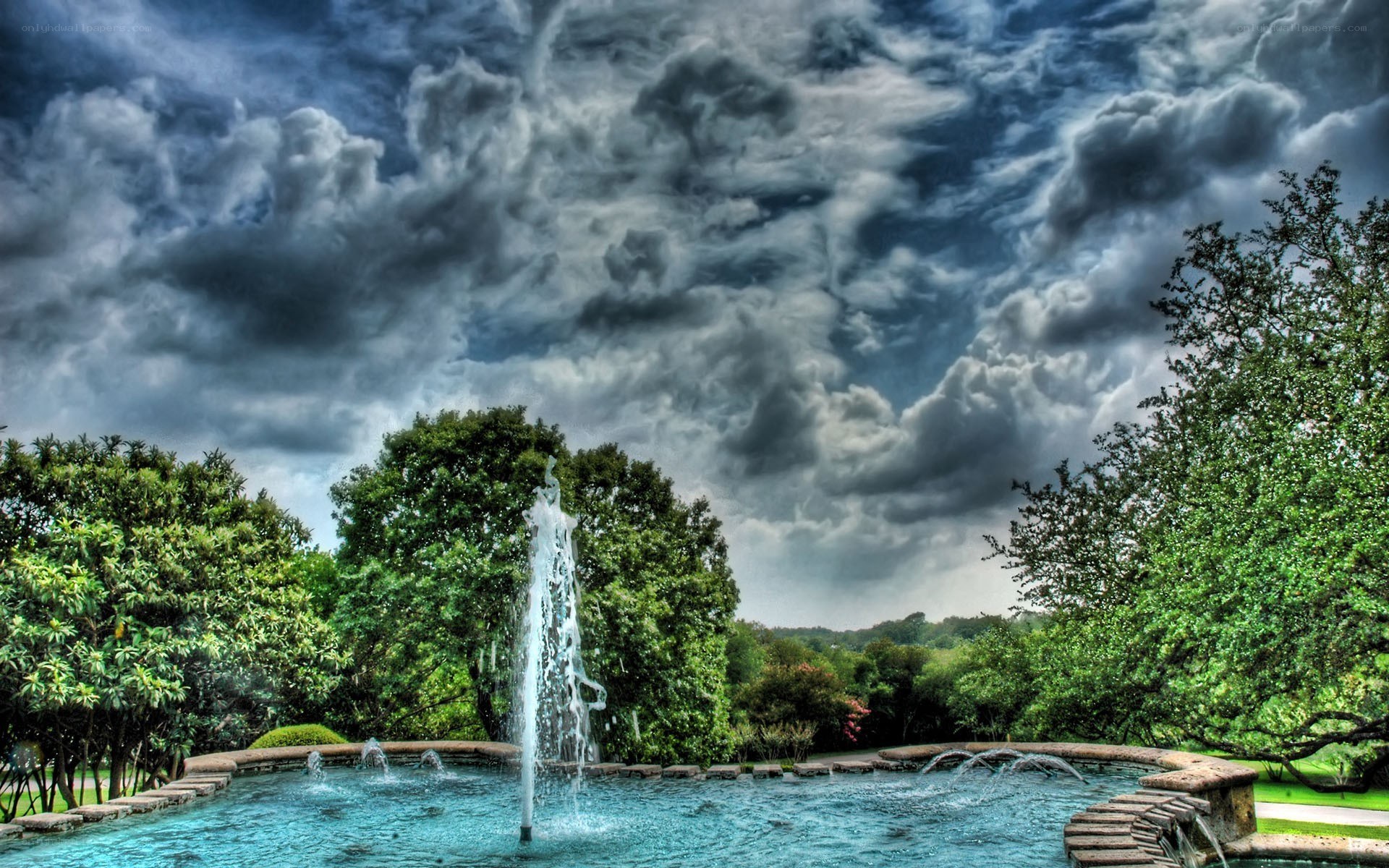 Fountain under stormy sky