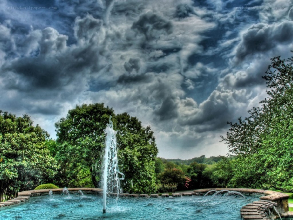 Fountain under stormy sky