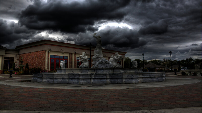fountain under stormy sky