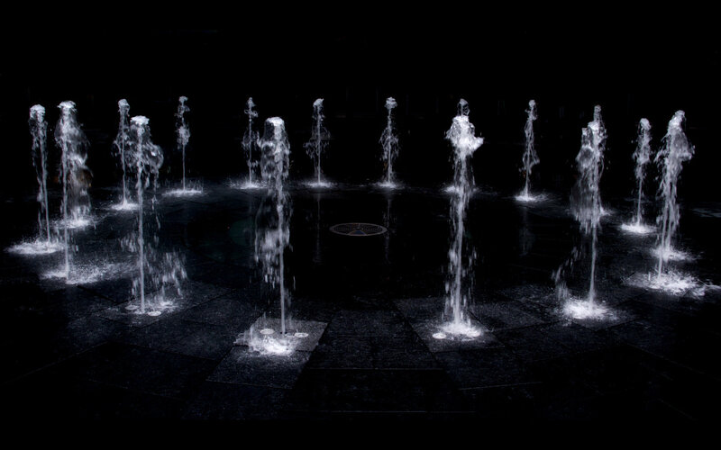 Fountains in a dark plaza