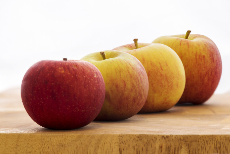 Four Apples on Wood