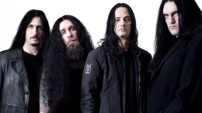 four band members in black