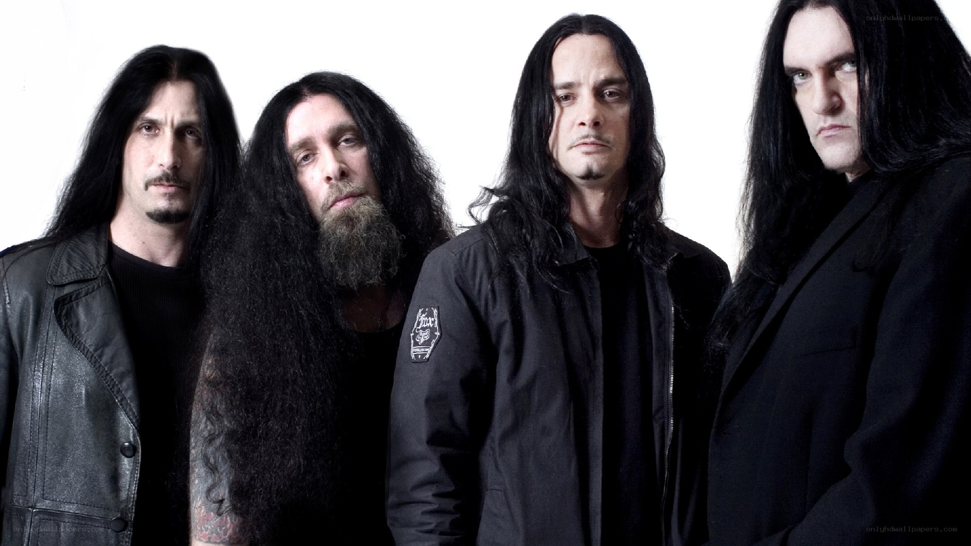 four band members in black