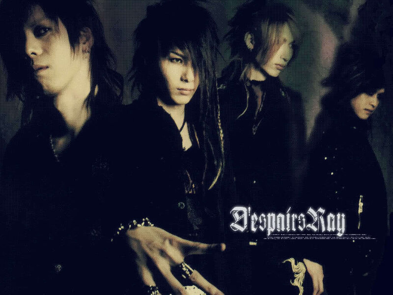 Four Band Members in Dark Clothing