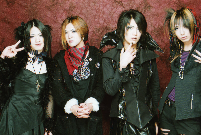 four band members posing