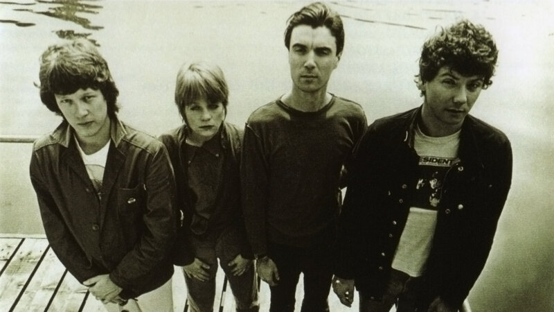 Four Band Members Standing — Black, Serious, Photograph