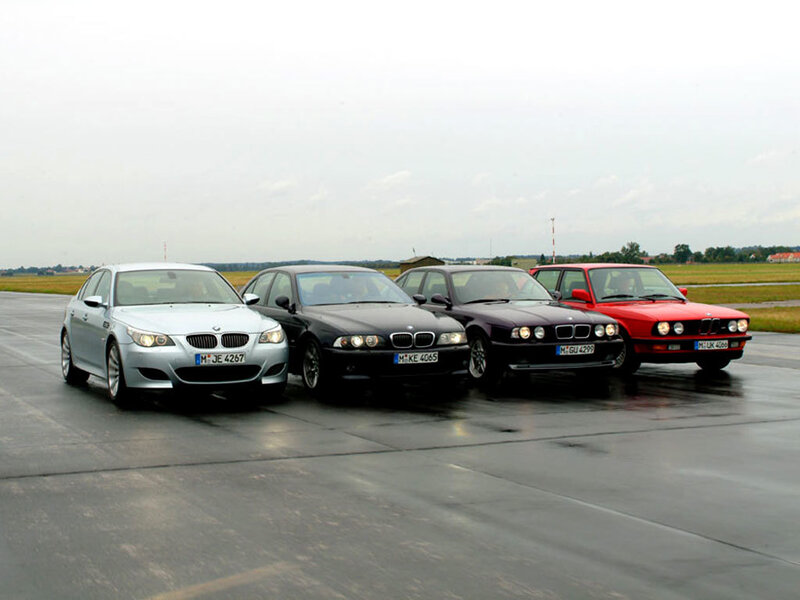 four bmw cars on a tarmac