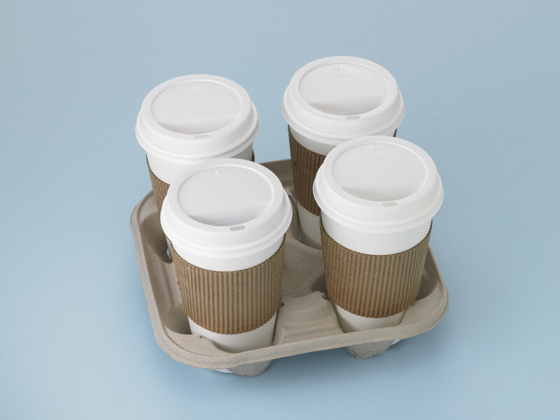 Four coffee cups in a carrier