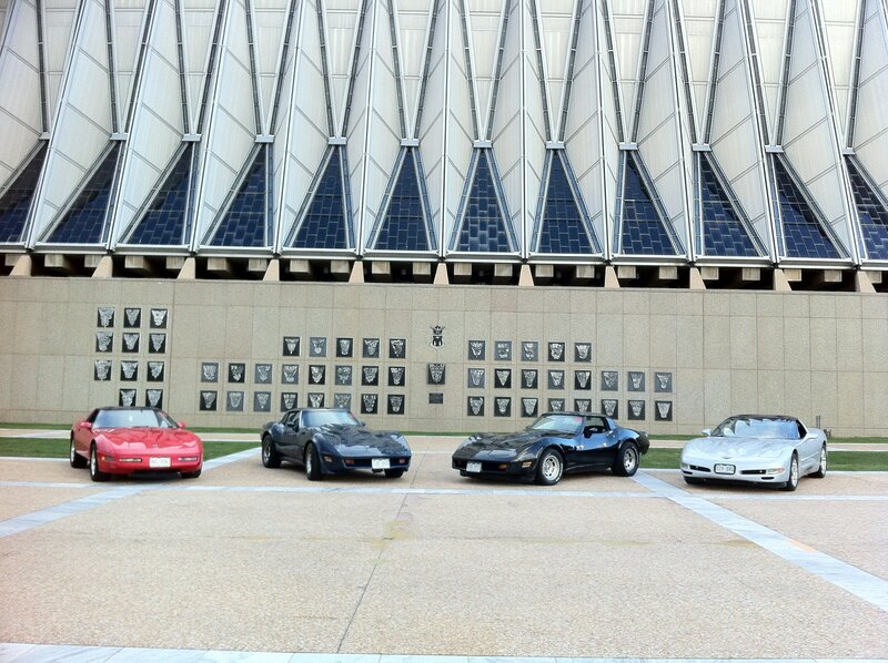 Four Corvettes in front of a building