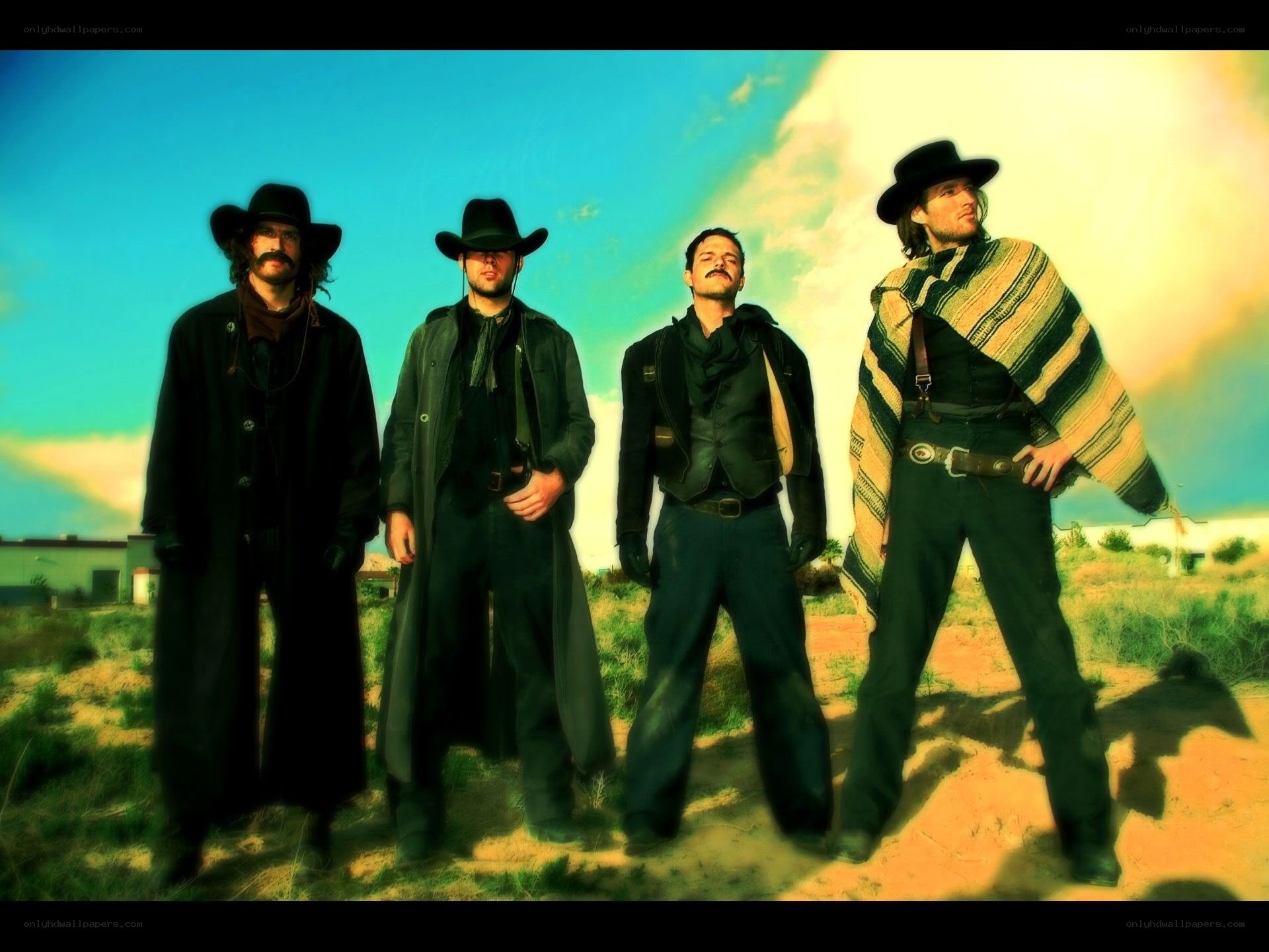 four cowboys in desert