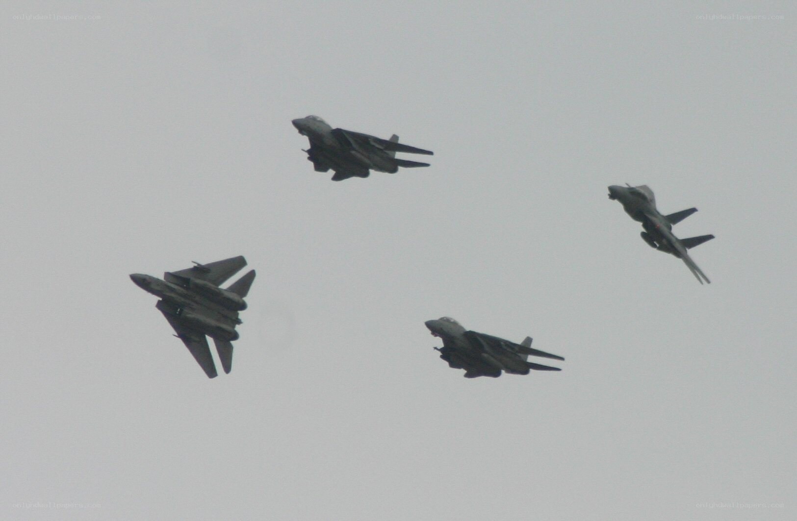 four fighter jets in formation