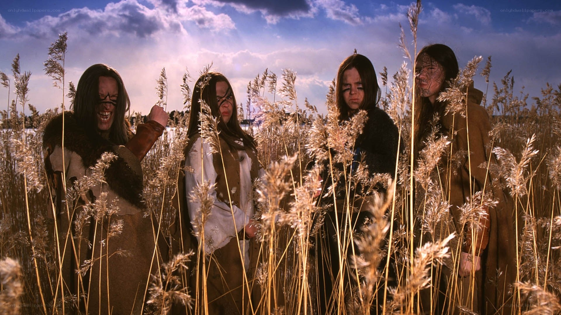 Four figures in a reed field