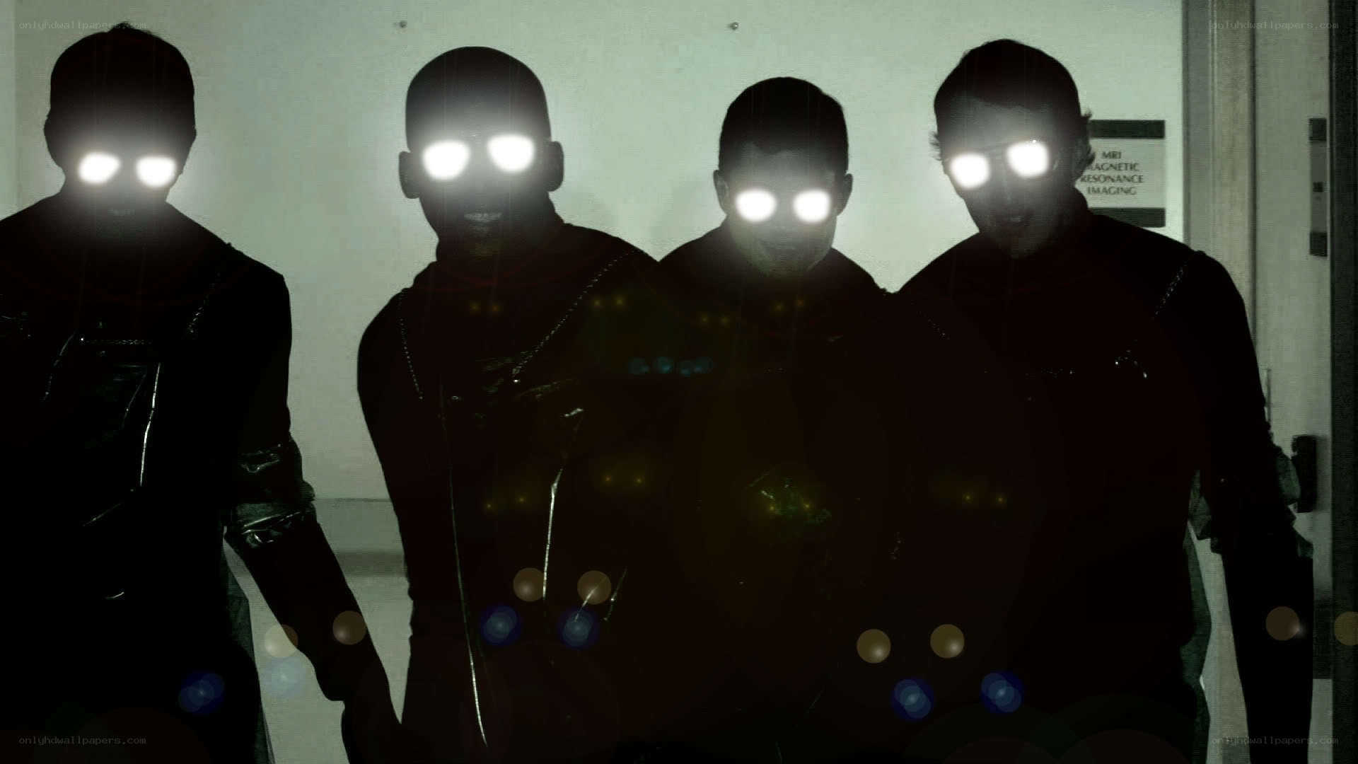 four figures with glowing eyes
