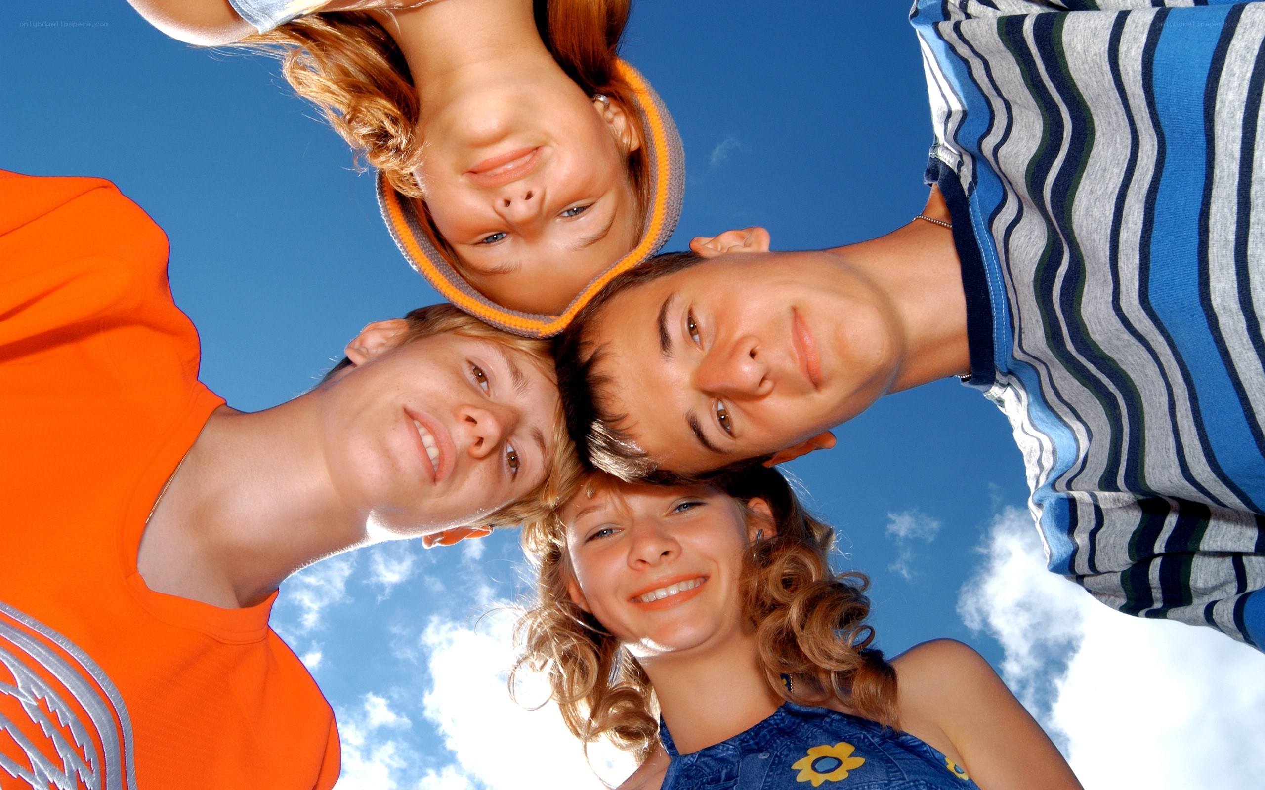 four friends looking down at camera
