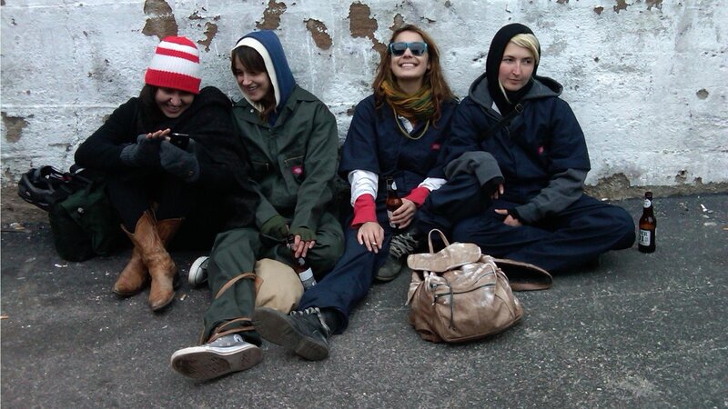 Four friends sitting on pavement