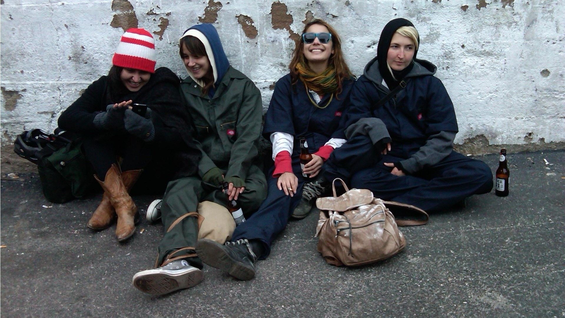 Four friends sitting on pavement