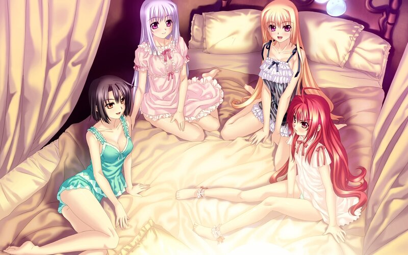 Four girls in pajamas on a bed