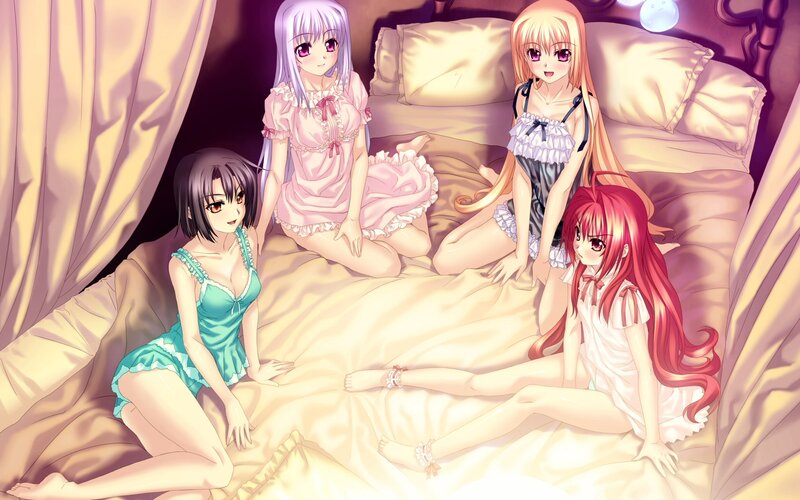 Four girls in pajamas on a bed