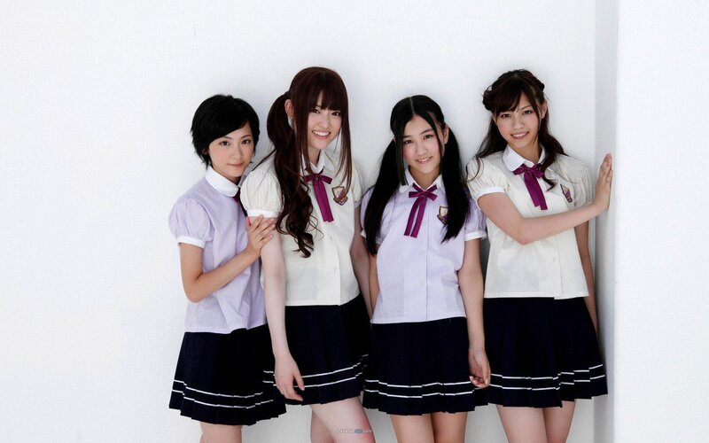 four girls in school uniforms