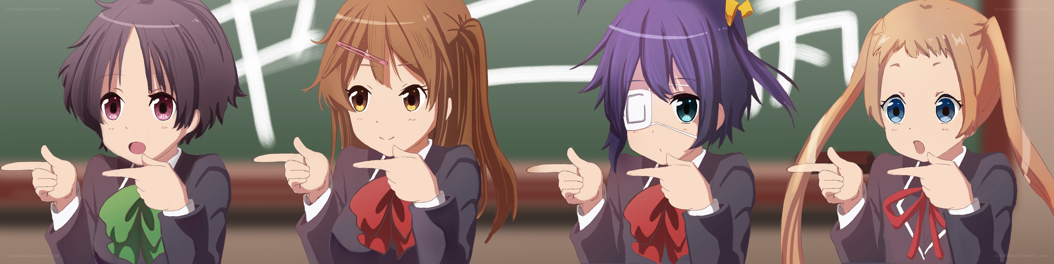 Four girls pointing in a classroom