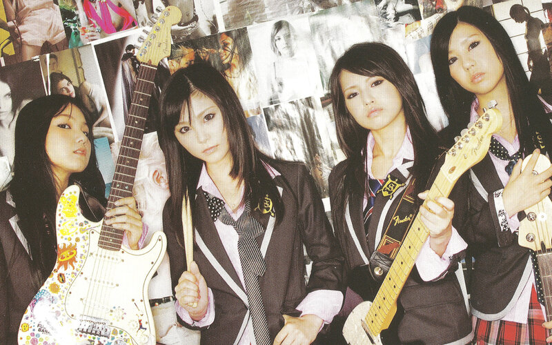 four girls with guitars in school uniforms