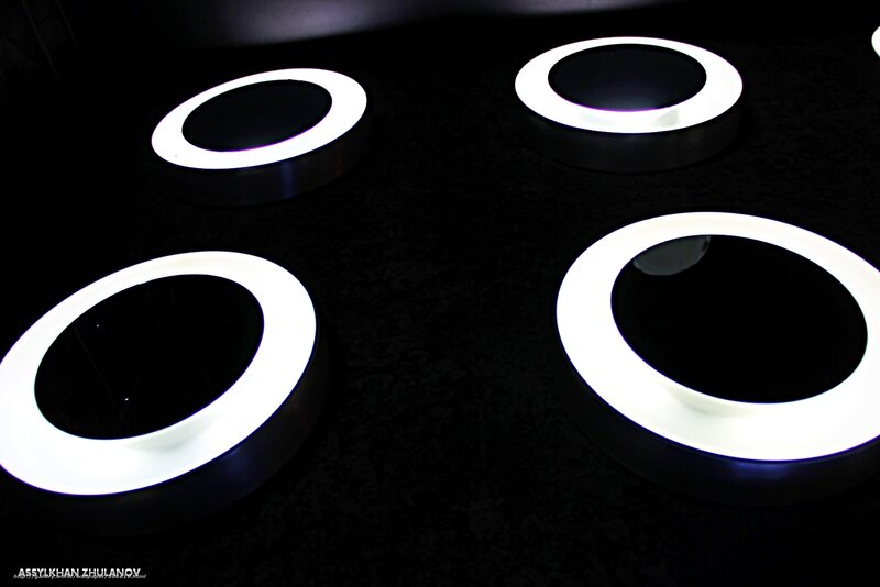 Four glowing rings on dark surface