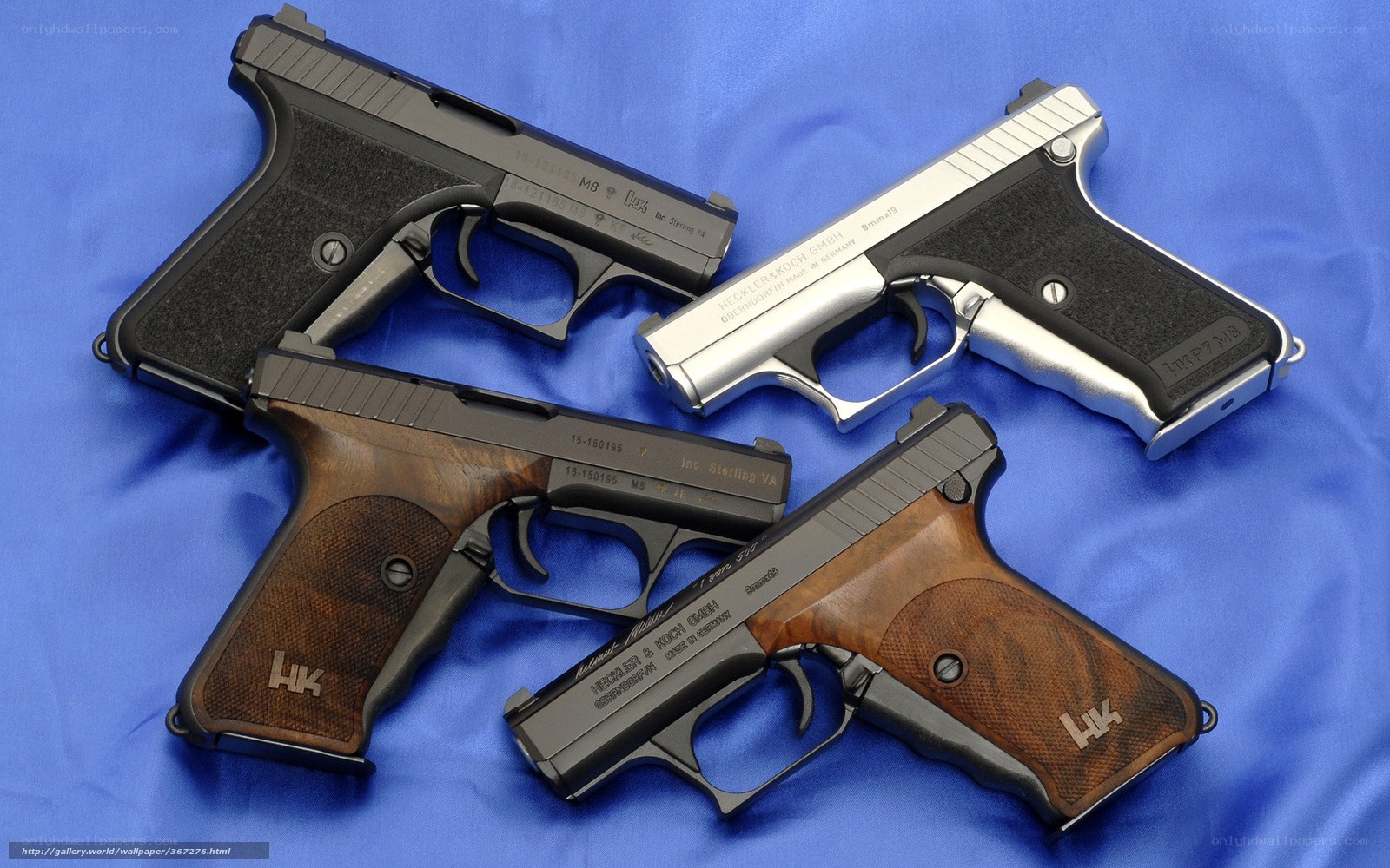 Four HK pistols on blue cloth