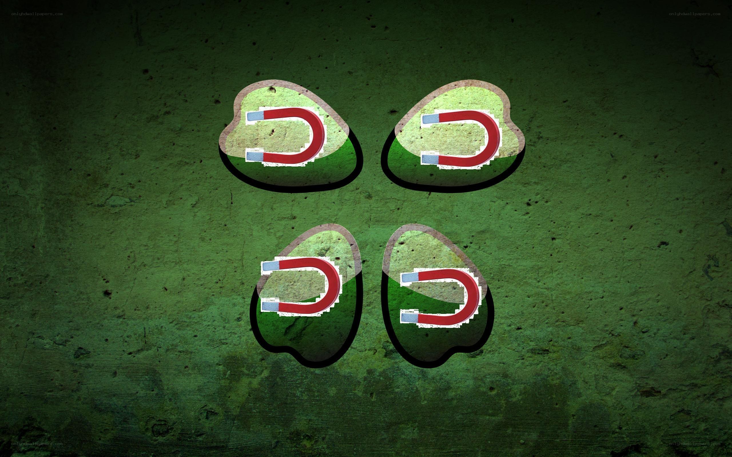 four magnets on green surface