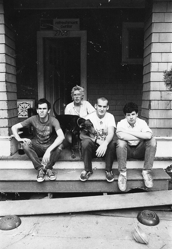 Four men and a dog on porch