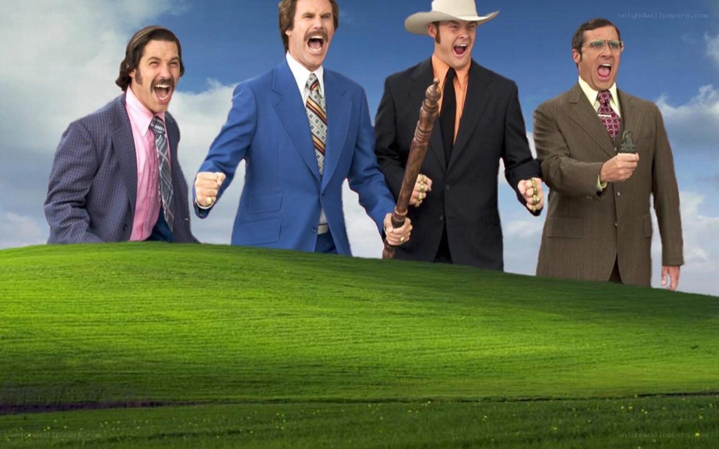 Four men cheering on a green hill