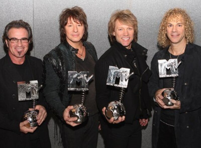 Four Men Holding Awards