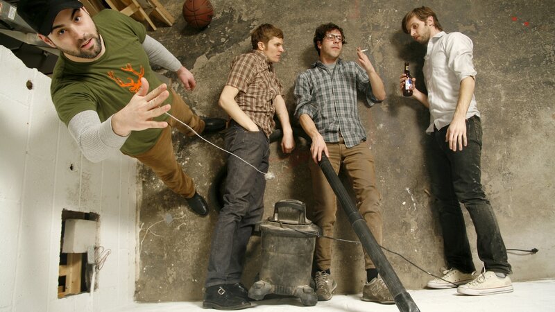 Four men in a basement