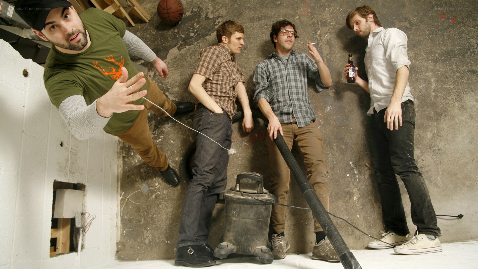 Four men in a basement