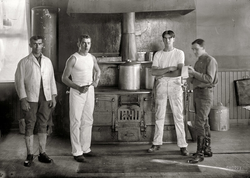Four men in a kitchen